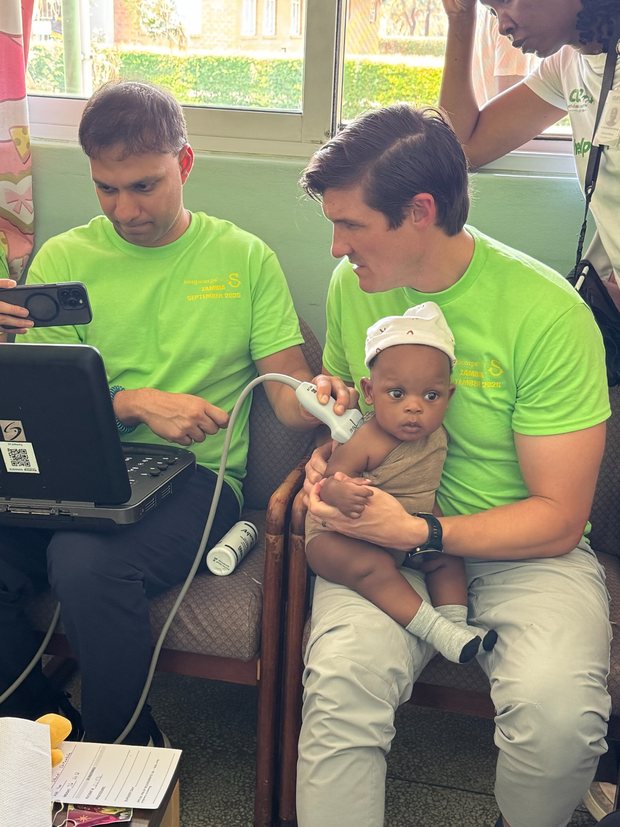 Dr. Irwin performing an ultrasound examination of an infant during a brachial plexus screening clinic in Zambia.